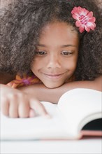 Mixed race girl reading book