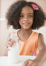 Mixed race girl drinking milk