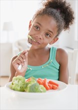 Mixed race girl eating healthy meal