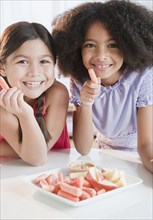 Girls eating fruits and vegetables for snack