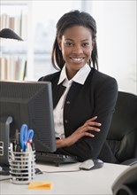 Mixed race businesswoman sitting at desk