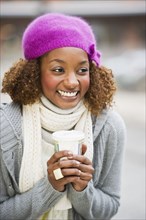 Mixed race woman drinking coffee