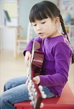 Chinese girl playing guitar