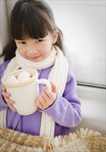 Chinese girl drinking hot chocolate