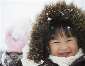 Chinese girl holding snowball