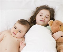 Mixed race girl sleeping with baby brother
