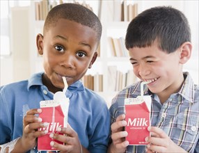Boys drinking milk from carton
