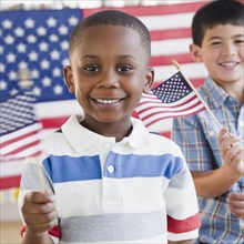 Boys holding small American flags