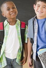 Smiling boys wearing backpacks