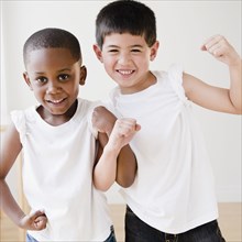 Smiling boys flexing biceps