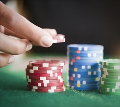 Hand holding gambling chips