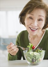 Japanese woman eating salad