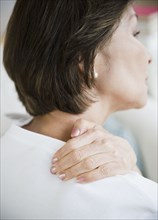 Japanese woman rubbing neck and shoulders