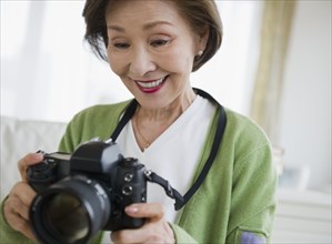 Japanese woman holding digital camera