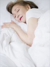 Japanese woman sleeping in bed