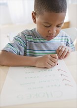 African American boy checking list of chores