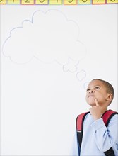 African American boy in school with thought bubble