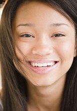 Close up of smiling mixed race teenage girl