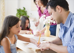 Parents helping children with homework