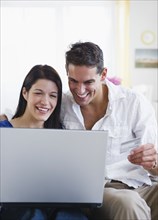 Mixed race couple shopping online with credit card