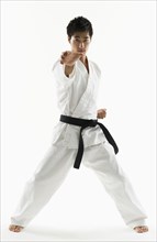 Asian male black belt practicing karate