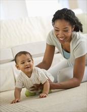 Mixed race mother playing with baby