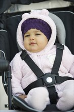 Mixed race baby in car seat