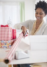 Black woman wrapping gifts