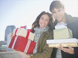Couple carrying Christmas gifts