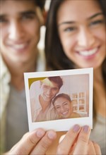 Couple holding photograph of themselves