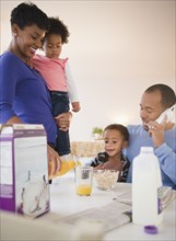 Black family eating breakfast together
