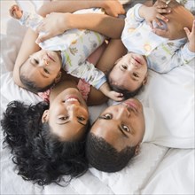 Family laying on floor with baby twins