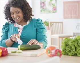 African American woman slicing vegetables