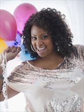 African American woman holding balloons