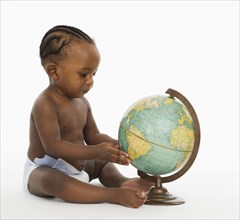African American baby looking at globe