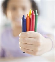 African American girl holding crayons