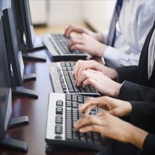 Business people working together in office on computers
