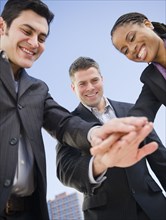 Business people clasping hands together