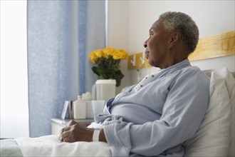 Black woman recovering in hospital bed