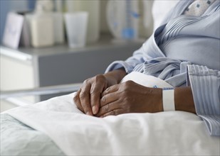 Black woman recovering in hospital bed