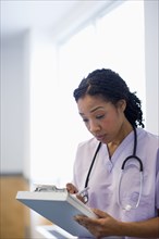 Nurse writing in medical record in hospital