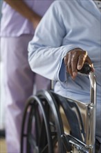 Nurse pushing woman in wheelchair