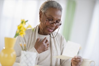 Black woman reading letter