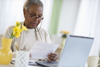 Black woman paying bills online