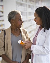 Pharmacist explaining medication to woman