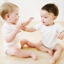 Babies playing on floor