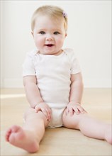 Caucasian baby sitting on floor