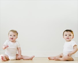 Babies sitting on floor