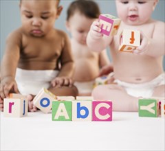 Babies playing with alphabet blocks