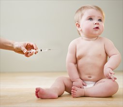 Doctor giving Caucasian baby injection
